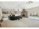 Spacious living room with fireplace and access to the pool area at 7941 Sycamore Dr, New Port Richey, FL 34654