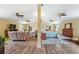 Open-concept living room with ceiling fans, hardwood floors and furniture sets at 7941 Sycamore Dr, New Port Richey, FL 34654