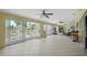 Bright living room area with tiled floor and multiple ceiling fans at 7941 Sycamore Dr, New Port Richey, FL 34654