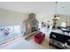 Living room features a stone fireplace and sliding doors to pool area at 7941 Sycamore Dr, New Port Richey, FL 34654