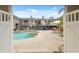 Inviting pool area with a spa, patio furniture, and well-maintained landscaping, framed by an open gate at 7941 Sycamore Dr, New Port Richey, FL 34654