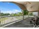 Outdoor porch area with comfortable seating, ceiling fans, and views of the green landscape at 7941 Sycamore Dr, New Port Richey, FL 34654
