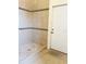 Large tiled shower with pebble floor and a door to exterior at 7941 Sycamore Dr, New Port Richey, FL 34654