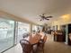 Bright sunroom with dining area and access to the pool at 7941 Sycamore Dr, New Port Richey, FL 34654