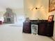 Wet bar with dark wood cabinets, granite countertop, and mini-fridge at 7941 Sycamore Dr, New Port Richey, FL 34654