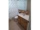 Bathroom featuring floral curtains, wooden vanity, and tiled floor at 8253 Saybrook Dr, Port Richey, FL 34668