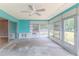 Enclosed sunroom offering ample natural light and a ceiling fan at 8455 Elgrove St, Spring Hill, FL 34608