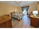 Bright bedroom with wood floors, ceiling fan, and sliding door to patio at 9163 Lingrove Rd, Weeki Wachee, FL 34613