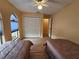 Bedroom with two twin beds and ceiling fan at 9163 Lingrove Rd, Weeki Wachee, FL 34613