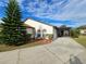Front view of a house with a carport and manicured landscaping at 9163 Lingrove Rd, Weeki Wachee, FL 34613