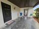 Front porch with seating and access to storage at 9163 Lingrove Rd, Weeki Wachee, FL 34613