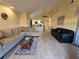 Living area with L-shaped sofa and view into the kitchen at 9163 Lingrove Rd, Weeki Wachee, FL 34613
