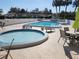Refreshing community pool and spa with patio furniture at 9163 Lingrove Rd, Weeki Wachee, FL 34613
