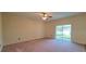 Large bedroom with carpeted floors and sliding glass doors to a patio at 10167 Bankston Dr, Hudson, FL 34667