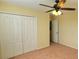 Bright bedroom with ceiling fan and double door closet at 10167 Bankston Dr, Hudson, FL 34667