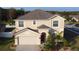 Two-story house with a red door, attached garage, and landscaping at 10167 Bankston Dr, Hudson, FL 34667
