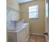 Convenient laundry room with washer, dryer and shelving at 10167 Bankston Dr, Hudson, FL 34667