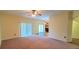 Living room with carpet, ceiling fan and sliding glass doors leading outside at 10167 Bankston Dr, Hudson, FL 34667