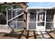 Screened patio adjacent to a pergola and wooden swing at 11366 Riddle Dr, Spring Hill, FL 34609