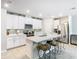 Modern kitchen with white cabinets, stainless steel appliances, and an island at 11701 Trumbull Dr, Spring Hill, FL 34609