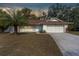 Front view of the house at dusk at 12216 Silk Oak Ln, Hudson, FL 34667