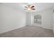 Bedroom with neutral walls, carpeted floor, natural light and ceiling fan at 12499 Convent Garden Rd, Brooksville, FL 34613