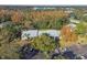 Aerial view showcasing condo building, parking, and trees at 1354 Shady Pine Way # H2, Tarpon Springs, FL 34688