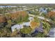 Aerial view of condo building with ample parking and fall foliage at 1354 Shady Pine Way # H2, Tarpon Springs, FL 34688