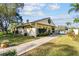 Community building with a brick pathway and landscaping at 1354 Shady Pine Way # H2, Tarpon Springs, FL 34688