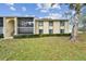 Condo building exterior showcasing landscaping and a tree at 1354 Shady Pine Way # H2, Tarpon Springs, FL 34688