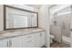 Bathroom with double vanity, large mirror, and a walk-in shower at 1852 Cypress Point Ln, Sarasota, FL 34234