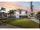 Newly constructed manufactured home with gray siding, landscaping, and a covered carport at 1852 Cypress Point Ln, Sarasota, FL 34234