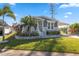 Mobile home with gray siding, landscaping, and a covered carport at 1852 Cypress Point Ln, Sarasota, FL 34234