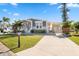 Newly constructed manufactured home with gray siding, landscaping, and a covered carport at 1852 Cypress Point Ln, Sarasota, FL 34234