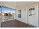 Covered front porch with wooden flooring and white railing at 1852 Cypress Point Ln, Sarasota, FL 34234