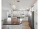 Modern kitchen with island, stainless steel appliances, and white cabinets at 1852 Cypress Point Ln, Sarasota, FL 34234