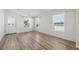 Living room with light walls and vinyl wood flooring, view of kitchen at 1852 Cypress Point Ln, Sarasota, FL 34234