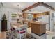 Bright kitchen with wood cabinets, island, and white appliances at 2300 Restmere Ln, Spring Hill, FL 34609