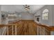 Bright and open-concept living room featuring wood floors, a vaulted ceiling, and a white stone fireplace at 24005 Frederick Dr, Brooksville, FL 34601