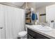 Clean bathroom with a shower/tub combo, floating shelves, and a pedestal sink at 26416 Mcallister St, Brooksville, FL 34602