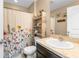 Updated bathroom with a shower/tub combo, floating shelves, and a pedestal sink at 26416 Mcallister St, Brooksville, FL 34602