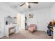 Charming bedroom with a vanity, comfortable armchair, and ample closet space at 26416 Mcallister St, Brooksville, FL 34602