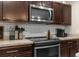 Close-up of kitchen with range, microwave, and granite countertop at 26416 Mcallister St, Brooksville, FL 34602
