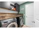 Well-equipped laundry room with modern washer and dryer, and stylish cabinetry at 26416 Mcallister St, Brooksville, FL 34602