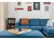 Cozy living room featuring a sectional sofa, wall decor, and a wooden tray on an ottoman at 26416 Mcallister St, Brooksville, FL 34602