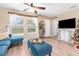 Living area with L-shaped sofa, decorative shelving and TV at 26416 Mcallister St, Brooksville, FL 34602