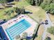 Aerial view of refreshing community pool with surrounding lounge chairs at 3644 Trophy Blvd, New Port Richey, FL 34655