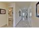 Hallway features gleaming tile floors and leads to bedrooms and living spaces, offering bright and airy transitions at 4148 Sand Ridge Blvd, Spring Hill, FL 34609