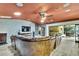 Spacious living room featuring a large brown sectional, tile floor, and a tiled fireplace at 4264 River Birch Dr, Spring Hill, FL 34607