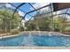 Screened pool with waterfall and spacious deck at 4264 River Birch Dr, Spring Hill, FL 34607